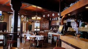 A restaurant with wooden interiors, a bar area, and a dining section with tables and chairs. - Lothringer Hof (Saarlouis)