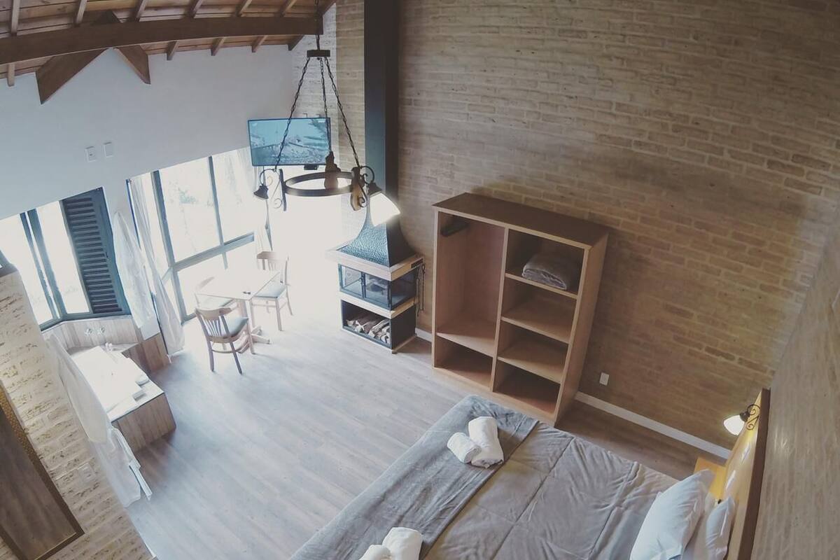 Ein Schlafzimmer mit einem großen Bett, einem Holzschrank, einem Schreibtisch und einem Stuhl.