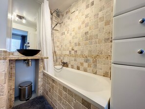 Bathtub, hair dryer, towels, soap