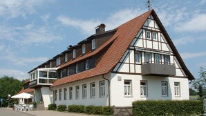 A traditional half-timbered building with a steeply pitched roof, multiple windows, and a balcony. - Zollersteighof (Albstadt)