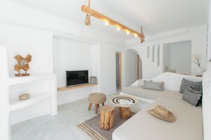 Duplex, Jetted Tub | Living area | 32-inch TV with satellite channels