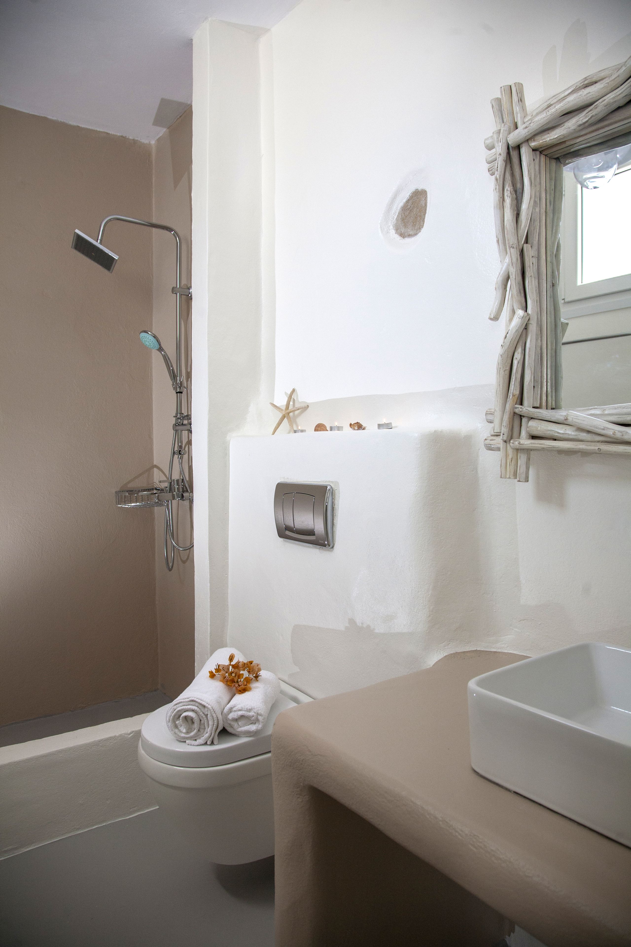A bathroom with a shower, toilet, and sink.