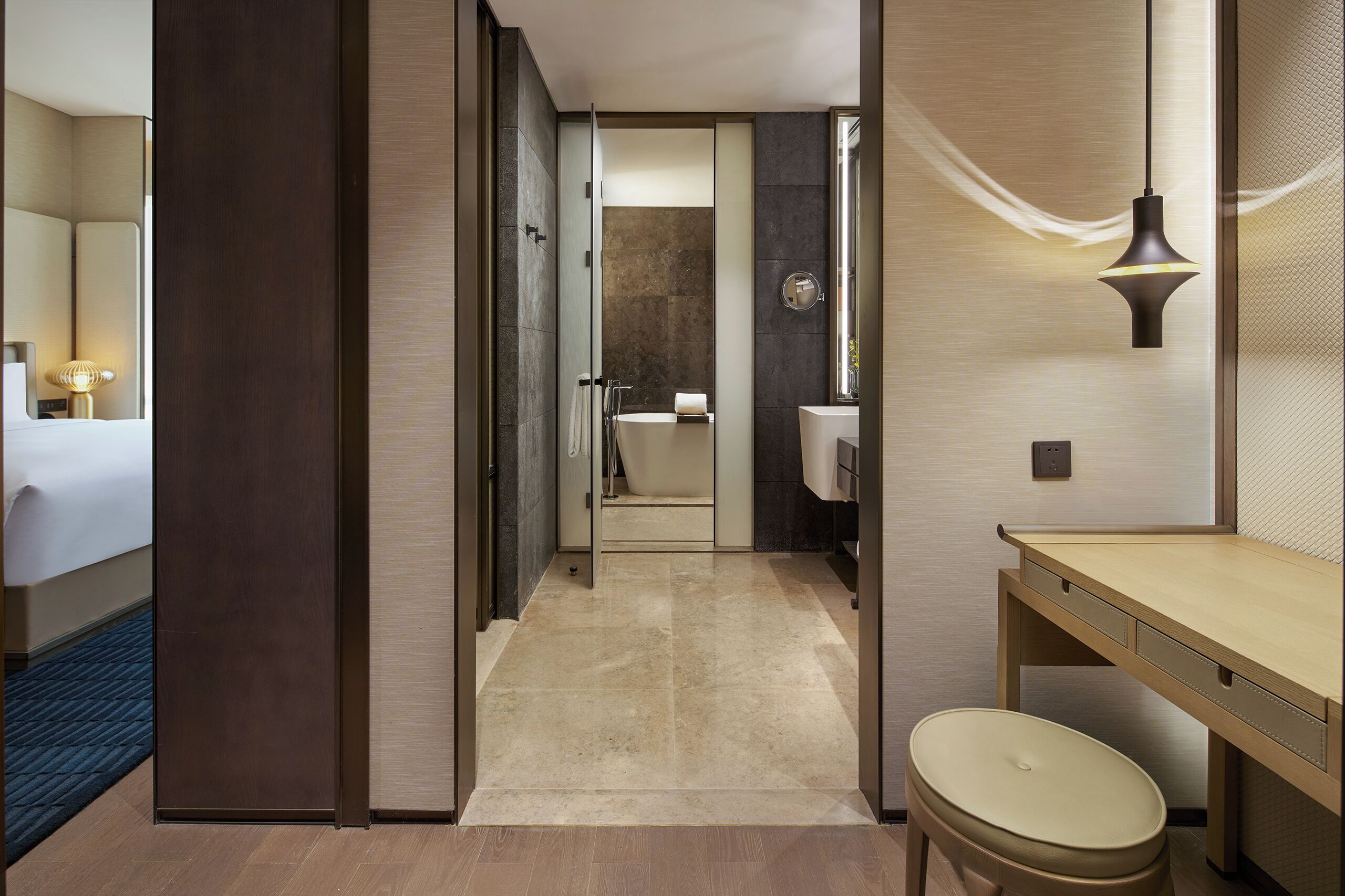A modern bathroom with a shower, toilet, and sink.