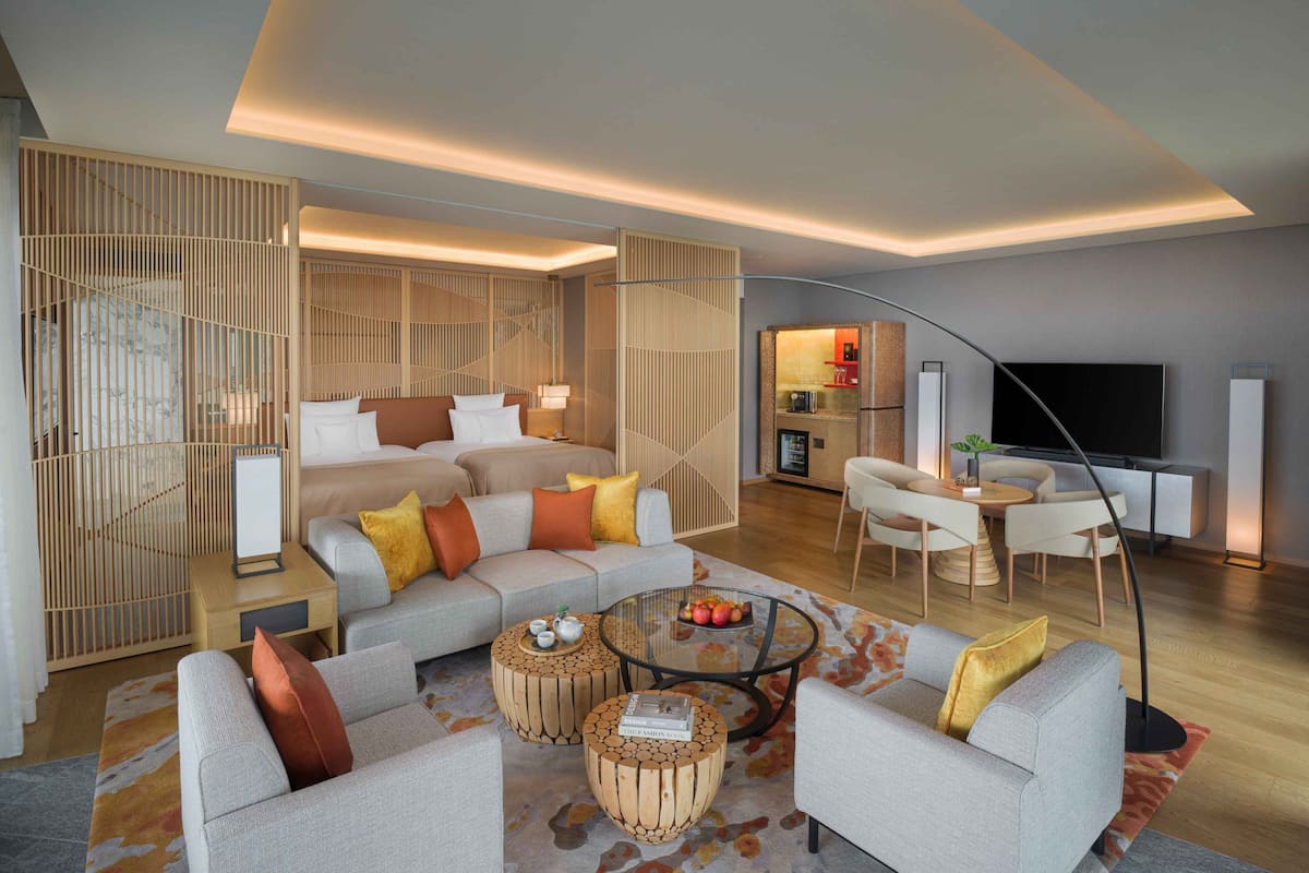 A modern living room with a sofa set, a coffee table, and a TV.