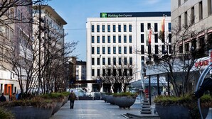 A Holiday Inn Express building with a modern facade, large windows, and a prominent sign. - Holiday Inn Express Mulheim - Ruhr by IHG (Muelheim an der Ruhr)