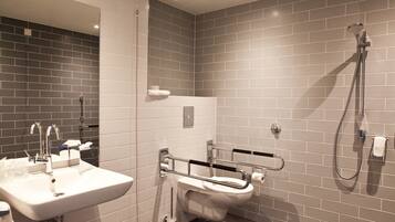 A modern bathroom with a sink, toilet, and shower.