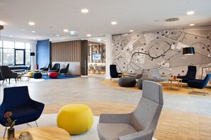 Relax in our spacious lobby with a comfortable seating area, interactive map, and modern amenities.