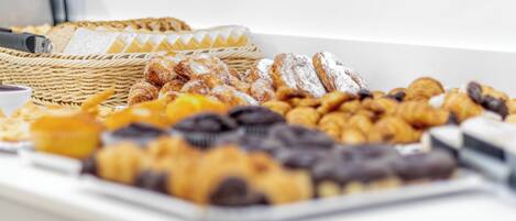A variety of pastries and baked goods displayed on a table.