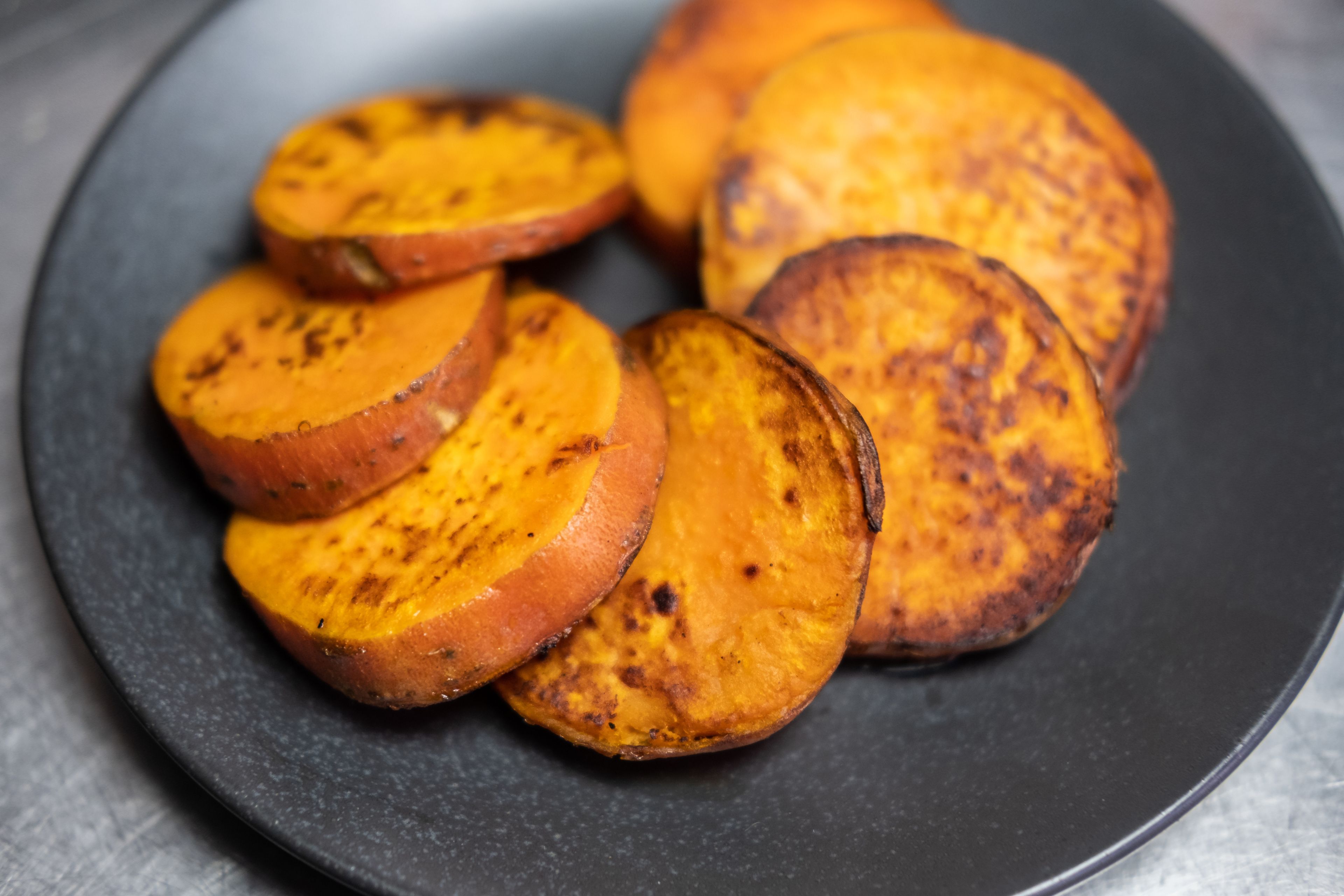 A plate of sliced roasted sweet potatoes.