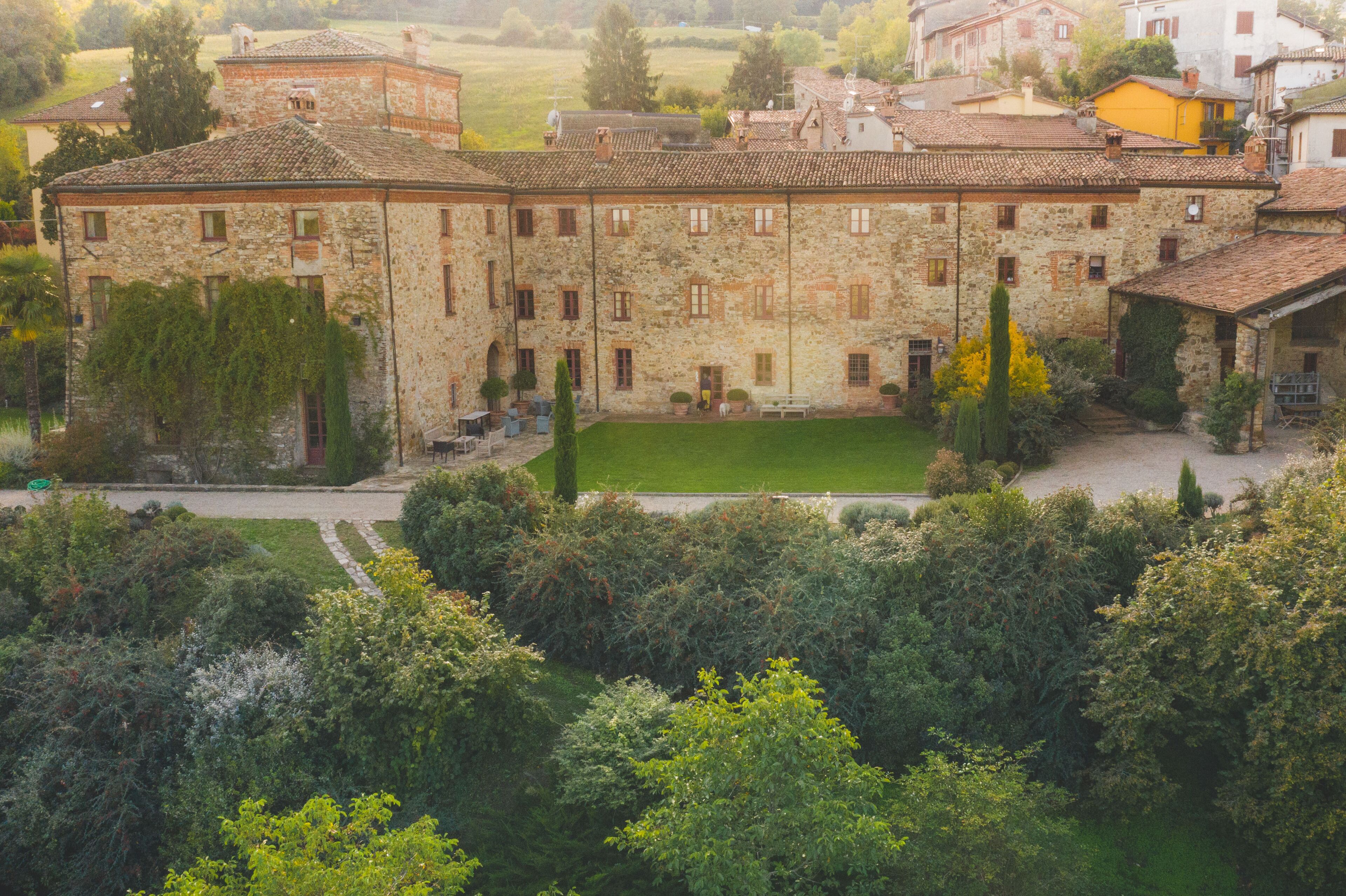 A stone building with multiple windows and a courtyard.