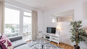 Apartment, 1 Bedroom | Living area | Flat-screen TV, DVD player