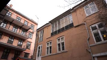 A multi-story building with balconies and windows.