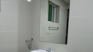 A bathroom with a white sink, a mirror, and a towel rack. - Kalamatiya Bird Sanctuary (Kalametiya)