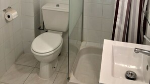 A bathroom with a toilet, a glass shower enclosure, and a sink. - Hostellerie du Pont Vieux (Sospel)