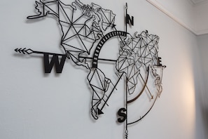 A wall-mounted compass with a geometric world map design. - Compass Point by Sorted Stay  (Southend-on-Sea)