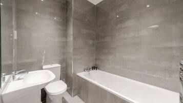 Combined shower/bathtub, deep-soaking bathtub, hair dryer, towels