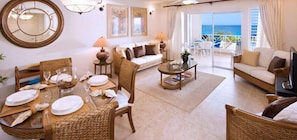 Enjoy meals and relaxation in this spacious room with a dining area, living space, and ocean views from the balcony.