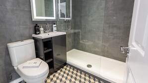 A bathroom with a toilet, sink, and shower. - Blue Suede Shoes (Southend-on-Sea)