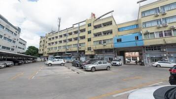 A multi-story parking garage with cars parked on the ground level.