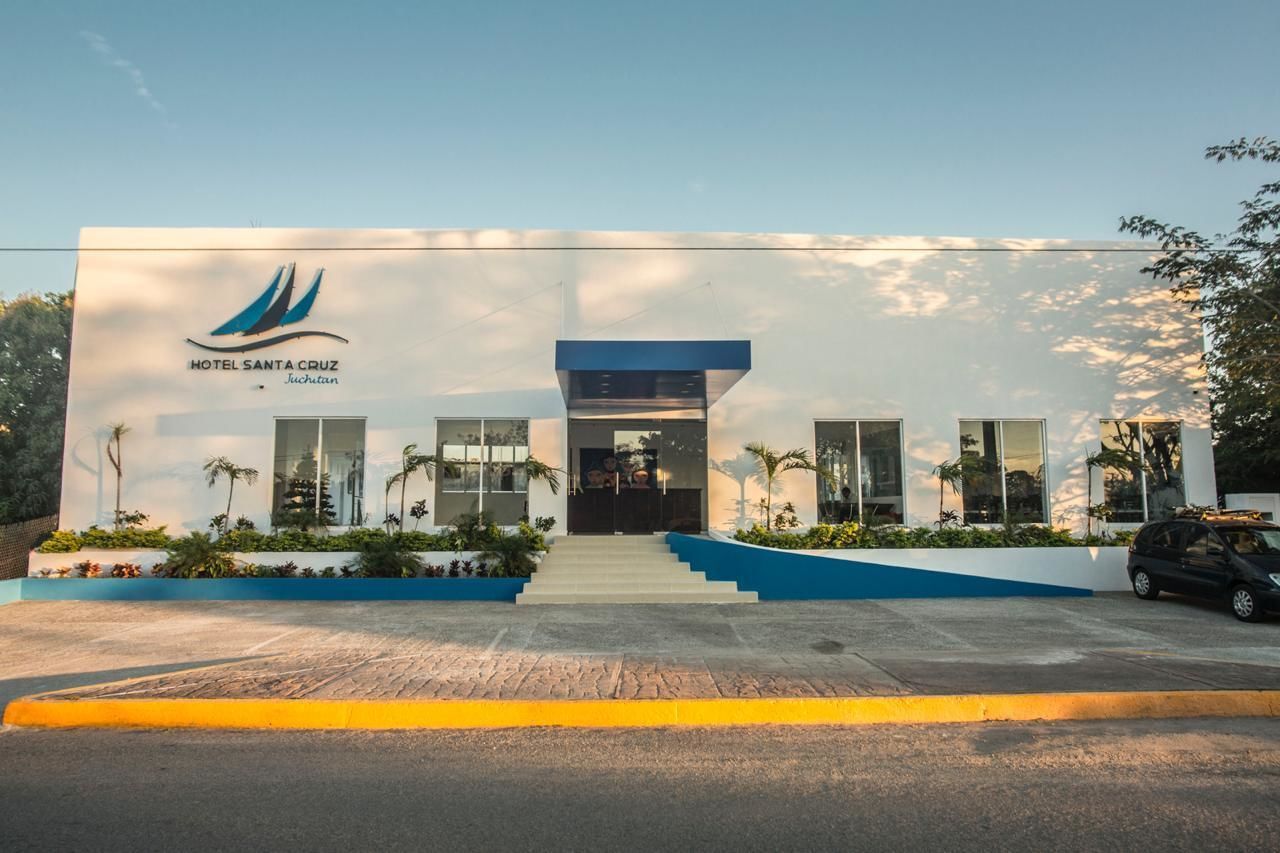 A modern hotel with a clear entrance, a logo, and a blue and white color scheme.