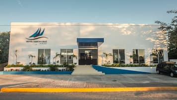 A modern hotel with a clear entrance, a logo, and a blue and white color scheme.
