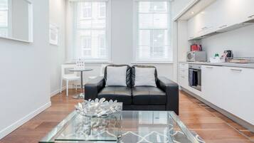 Apartment, 1 Bedroom | Living area | Flat-screen TV, DVD player