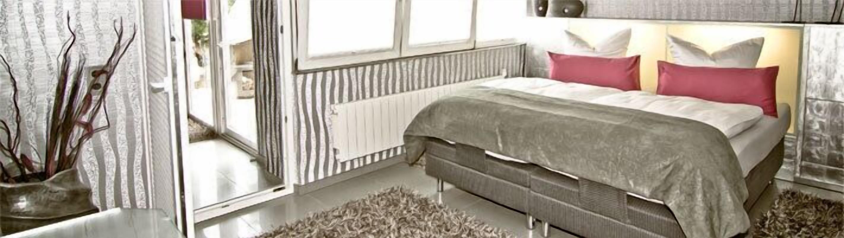 Une chambre à coucher avec un lit, un radiateur et une fenêtre.