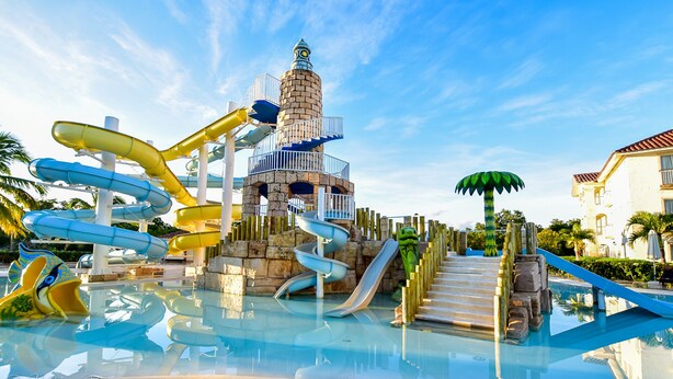 Un parque acuático con varias toboganes y una torre central.