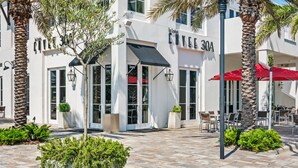 A modern building with a cafe named 'COVE 30A' and outdoor seating. - ⭐Only 2 Blocks to Beach~Wraparound Porch + Top Deck~Inlet Rose (Rosemary Beach)