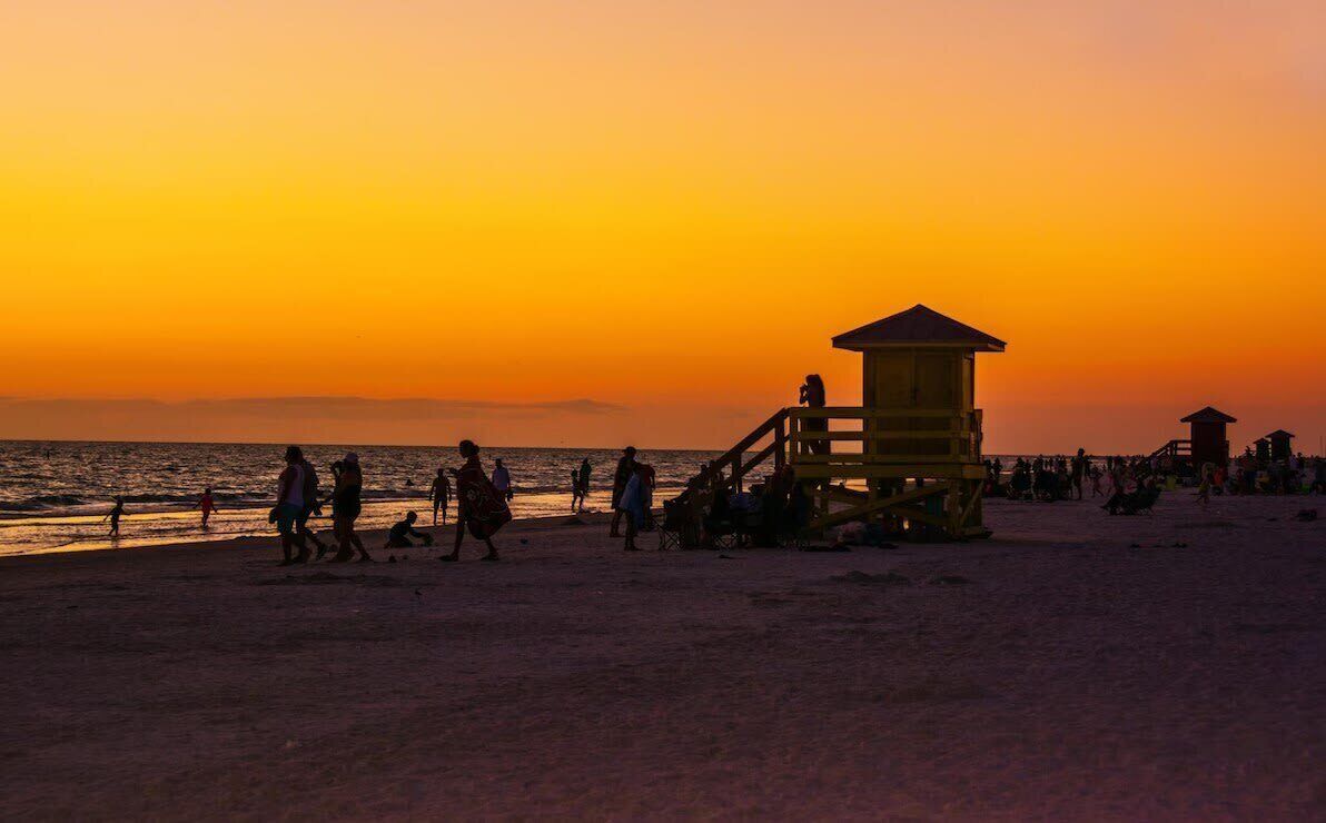 A lifeguard tower on a beach during sunset.