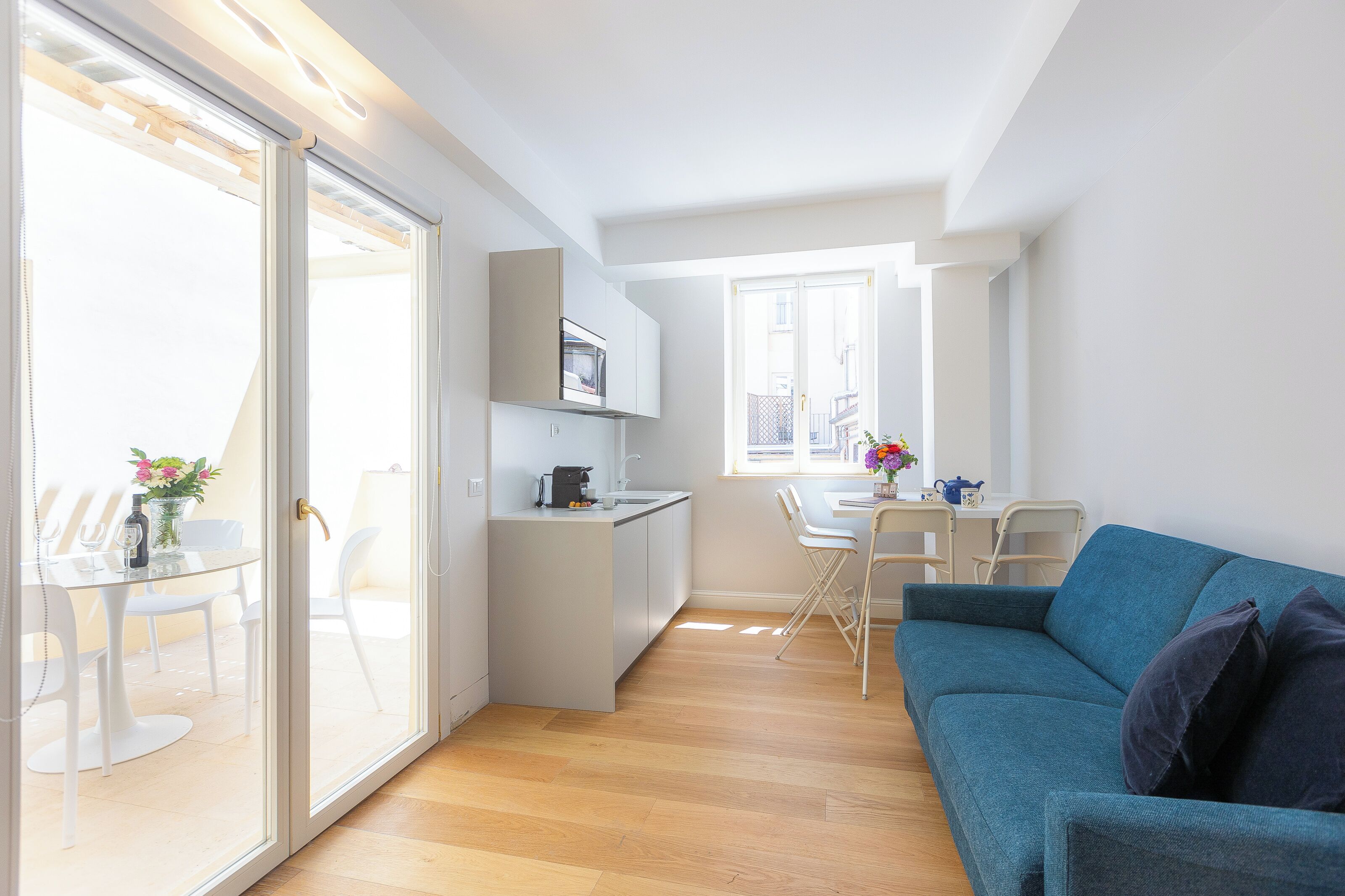 A modern apartment with a kitchen, dining area, and living room.