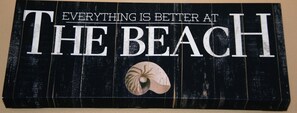 A sign with the text "EVERYTHING IS BETTER AT THE BEACH" and a seashell. - Baywatch by Surfside VR (Pensacola Beach)
