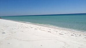 A beach with clear turquoise water and white sand. - Tristan Towers by Surfside VR (Pensacola Beach)