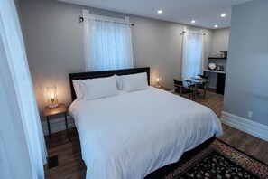 Premium bedding, pillow-top beds, laptop workspace, iron/ironing board