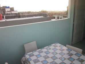 Enjoy the city view from this room, featuring a table and chair near the window.