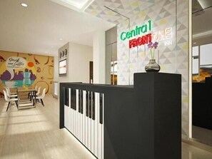 A reception desk with a sign reading "Central Frontline Inn."