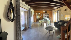 A spacious living room with a wooden staircase, a dining area with a table and chairs, and a cozy seating area with a sofa. - *** Perigord cottage with pool (Archignac)