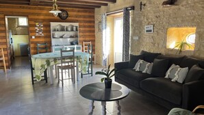 A cozy living room with a dining area, stone walls, and a WiFi password sign. - *** Perigord cottage with pool (Archignac)