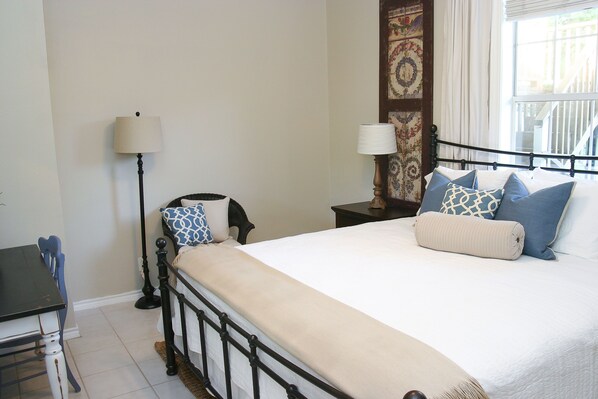 A neatly arranged bedroom with a bed, bedside tables, a lamp, and a chair. - Walk .4 Miles to Texas A&M Campus and Aggie Park, Private Entry /Covered Parking (College Station)