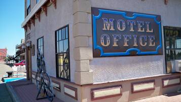A building with a sign reading "Motel Office" and a bicycle parked outside.