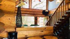A wooden interior with a wooden bench, a coffee maker, and a toaster. - Waterfront Cabin w/ Stunning Lake Views & Porch (Burnet)