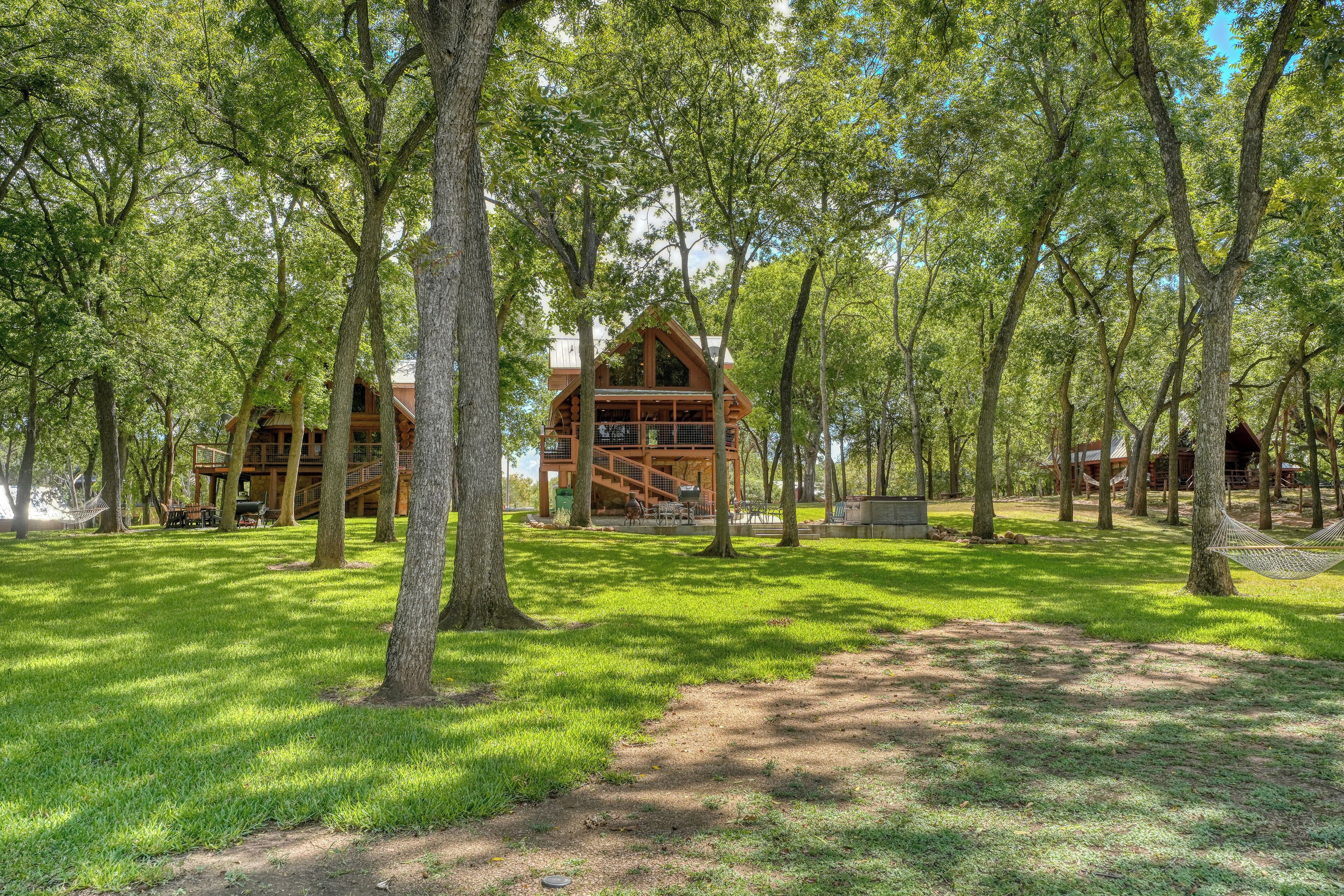 A cabin-style building surrounded by trees in a wooded area.