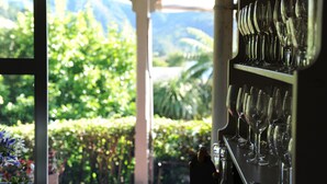 A bar area with a view of lush greenery and mountains. - Tirimoana House (Anakiwa)