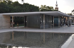 A modern building with a reflective pool in front. - Charming, Luminous & Quiet, Top floor, Big Terrace, WIFI, Centric. (Barcelona)