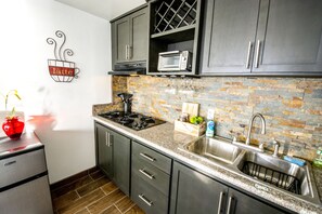 Fridge, microwave, coffee/tea maker, cookware/dishes/utensils
