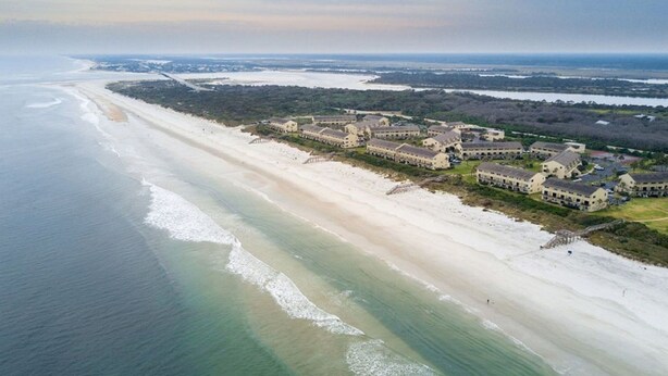 An aerial view of a coastal resort with beachfront properties and a large building complex. - Summerhouse 101:  Luxury Condo on Beach (St. Augustine)