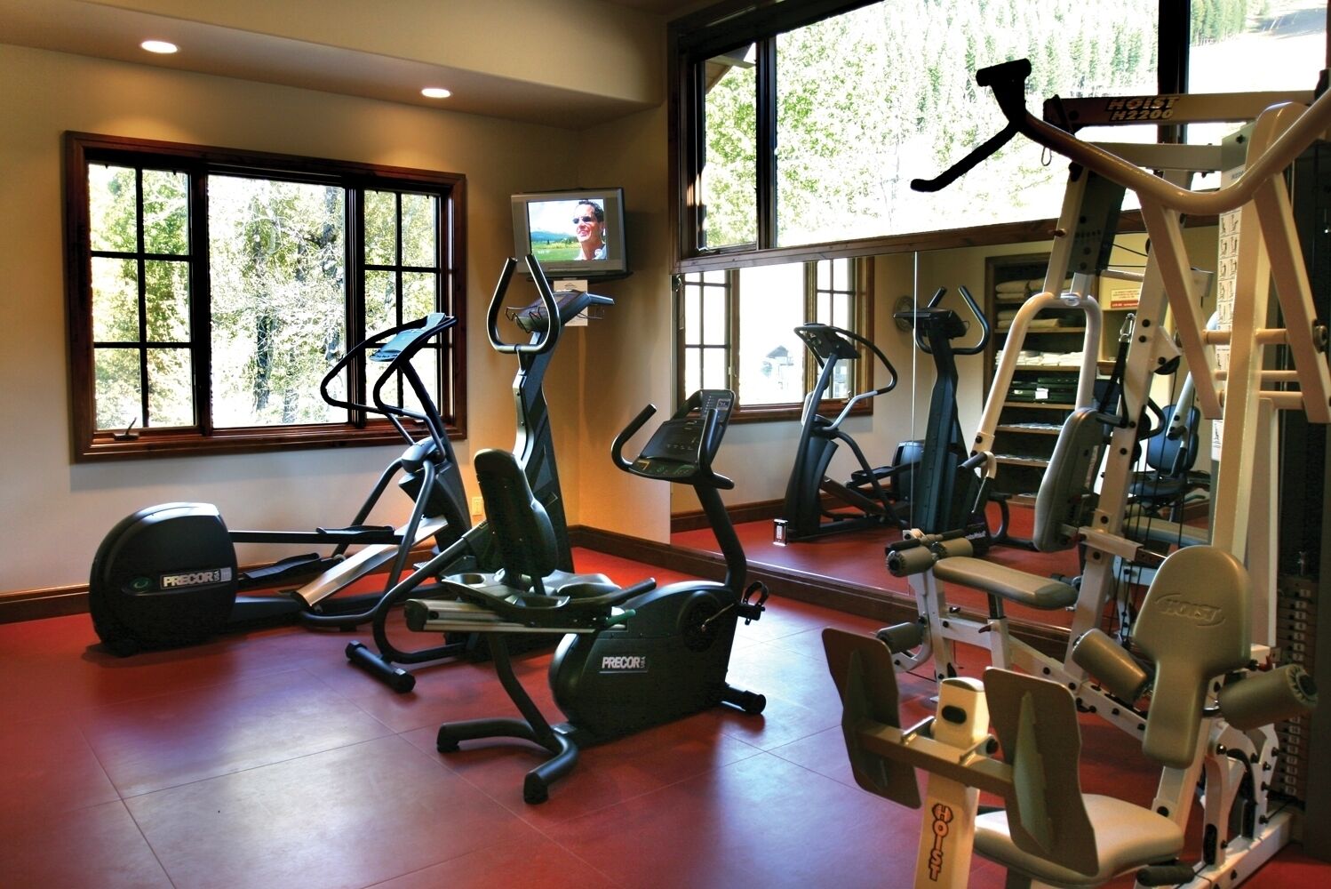 A gym with treadmills, elliptical machines, and weightlifting equipment.