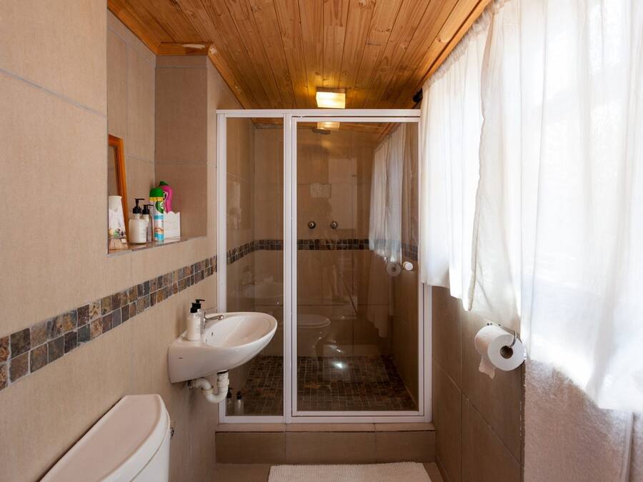 Un bagno con doccia, WC e lavandino.