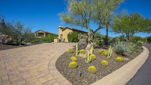 A house with a paved driveway, surrounded by cacti and desert plants. - Private with Mountain Views and City Lights (Scottsdale)