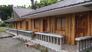 A wooden building with a porch, stone steps, and a gravel driveway. - Punta Aguila Resort & Hotel (San Juan)